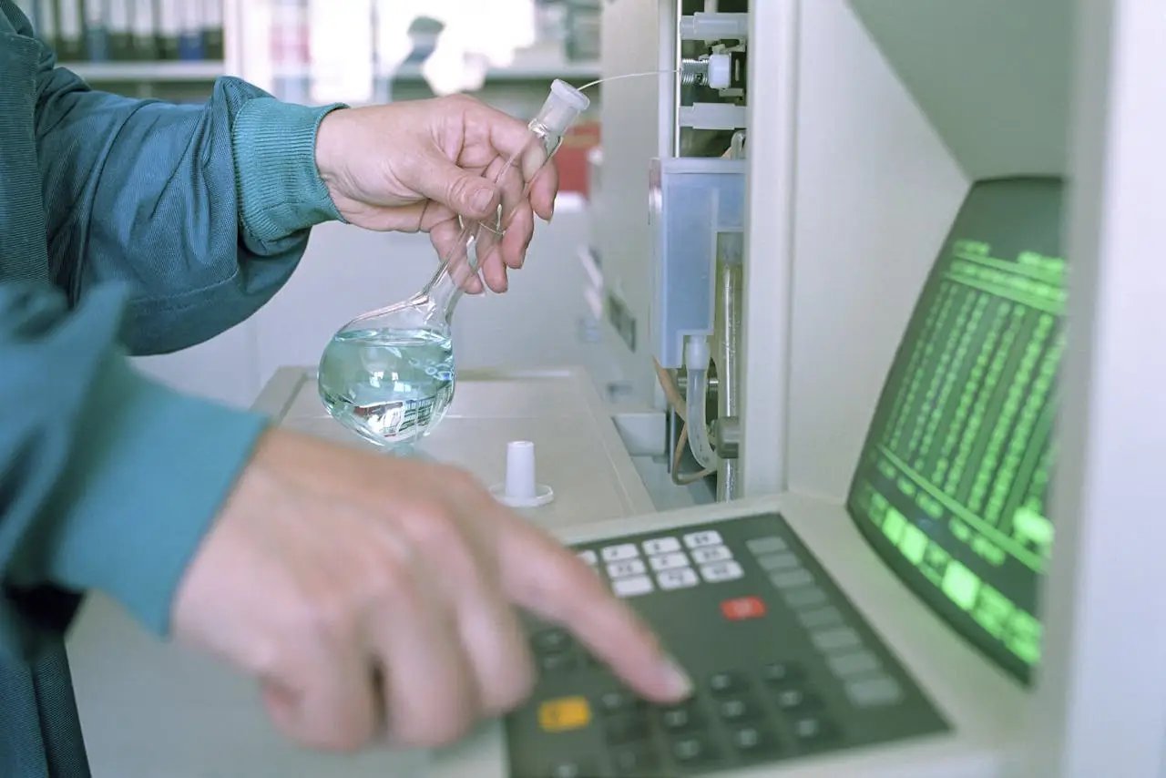 why-choose-us Close-up of a scientist operating lab equipment with a flask in hand.